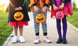 Happy Halloween! legs of funny children in carnival costumes outdoors