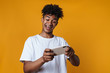 © Drobot Dean - Image of excited african american guy playing online game on cellphone