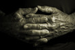 Elder senior adult  with crossed wrinkled hands - black background