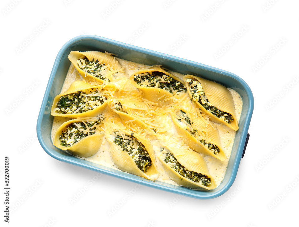 Baking dish with tasty conchiglioni pasta on white background