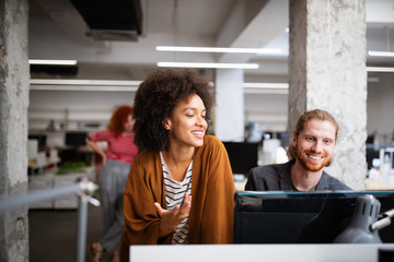 Programmers cooperating at IT company developing apps