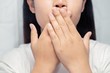 Women have bad breath due to inflamed gums.