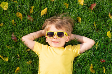 Poster - Happy child having fun outdoor in autumn park