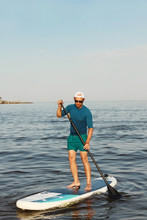 Man Is Training On A SUP Board.
