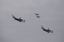 The RAF's Iconic Avro Lancaster Heavy Bomber Escorted By Supermaine Spitfires