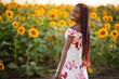 © AS Photo Family - Pretty young black woman wear summer dress pose in a sunflower field.