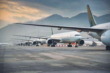due to coronavirus covid-19 airline fleet parked at the taxiway of airport