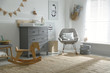 © New Africa - Beautiful baby room interior with toys, rocking chair and modern changing table