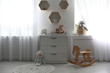 © New Africa - Beautiful baby room interior with toys and modern changing table