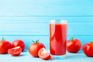 Fresh tomatoes with paste and juice on grey background