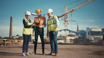 Wall Mural - Diverse Team of Specialists Use Tablet Computer on Construction Site. Real Estate Building Project with Civil Engineer, Architect, Business Investor Discussing Planning and Development Details.