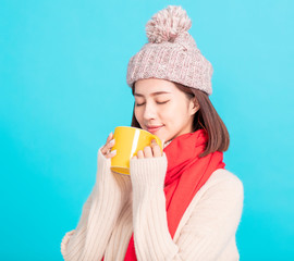 Wall Mural - young woman Enjoying a Cup of Hot Tea in Hands