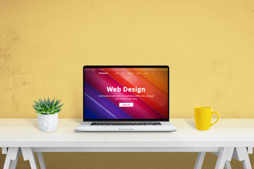 Fototapete - Web design creative website concept. Laptop computer on desk with plant and coffee mug beside