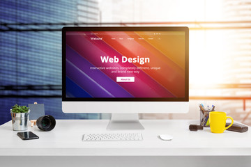 Wall Mural - modern web design studio office with modern flat design website on computer display concept