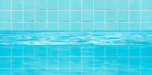 Side View Of Blue Tiles Mosaic Wall With Water Texture In Swimming Pool.