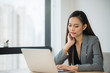© Nopphon - Beautiful asian businesswoman using laptop working in office and smiling.