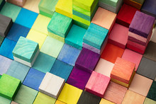 Spectrum Of Stacked Multi-colored Wooden Blocks. Background Or Cover For Something Creative, Diverse, Expanding, Rising Or Growing. 