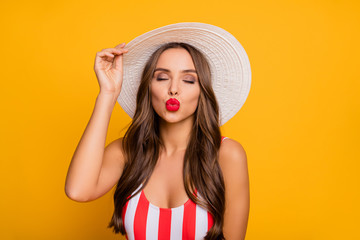 Poster - Photo of adorable gentle lady perfect long hairstyle sexy smooth bronze body send boyfriend air kisses red lips wear sun hat striped swim bodysuit isolated bright yellow color background