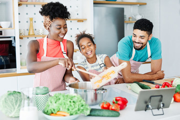 Wall Mural - family child kitchen food daughter mother father cooking preparing breakfast  happy together