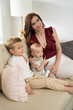 © Evgenia Tiplyashina - Mom with children in the room
