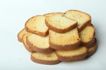 Sticker - Closeup of slices of loaf bread carefully stacked like a small tower on a white surface