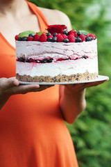 The housewife keeps a freshly prepared cake with seasonal fruit. Home made cake. Food photography.