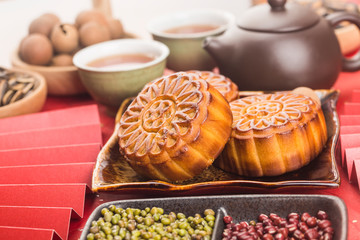 Poster - Mid-Autumn Festival concept, Traditional mooncakes on table  with teacup.