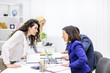 © Andrii - Photo of young business partners sharing ideas and planning work at meeting in office.