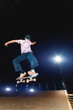 © yanik88 - A young skater does the trick of sliding at night in a skatepark. The concept of night leisure and youth culture at night