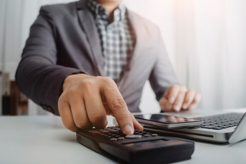 Business people use tablets and hold credit cards as an online shopping concept With a calculator and a book placed on the table with film grain effect