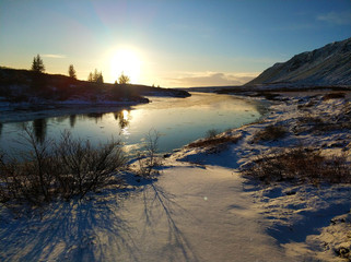 Wall Mural - Iceland's breathtaking winter landscapes. River with pieces of ice on the background of mountains