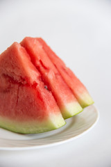 sliced ​​watermelon on a plate isolated on white background