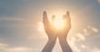 © kieferpix - hands in the sky holding the sun. Spiritual healing concept.