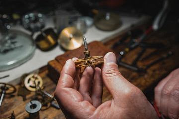 Canvas Print - High angle shot of a male working on repairing a watch