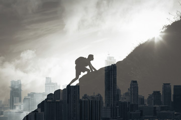 Wall Mural - Young determined man climbing up mountain overlooking the city. People, power, challenging yourself, never giving up, and hard work concept. Double exposure 