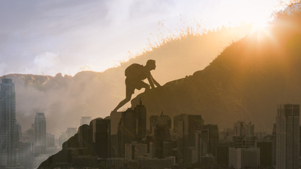 Wall Mural - Young determined man climbing up mountain overlooking the city. People, power, challenging yourself, never giving up, and hard work concept. Double exposure

