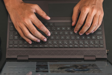 Sticker - High angle shot of male hands using a laptop