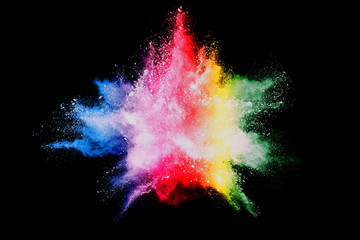 Wall Mural - explosion of colored powder isolated on black background.