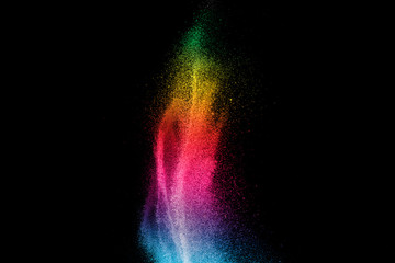 Wall Mural - explosion of colored powder isolated on black background.