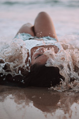 Poster - Selective focus shot of a hot young Caucasian female in shorts enjoying the beach