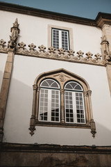 Wall Mural - Closeup shot of the antique building with gothic windows in Lamego City, Portugal