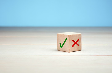 Wall Mural - wooden block with green check mark and red x. choice and decision making concept.