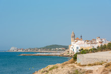 SITGES, SPAIN - Jul 29, 2020: Sandy Beach And Historic Old Town In The Mediterranean Complex S