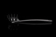 plastic cooking fork on black background isolated