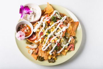Wall Mural - Chicken and cheese nachos with olives and sauce