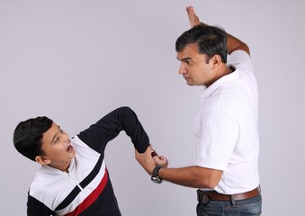 Indian father scolding his son.