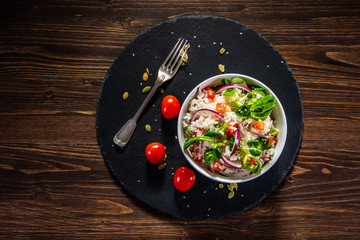 White rice and vegetables on wooden table