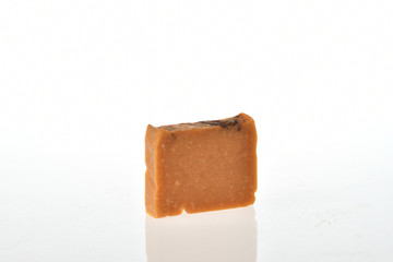 Poster - Closeup shot of natural organic brown soap isolated on a white background