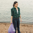 © Alexander - Taking care of our planet, fighting plastic garbage in nature. A young female volunteer