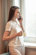 © VERSUSstudio - Beautiful woman talking on the phone